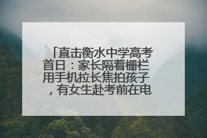 直击衡水中学高考首日：家长隔着栅栏用手机拉长焦拍孩子，有女生赴考前在电话亭与家人通话